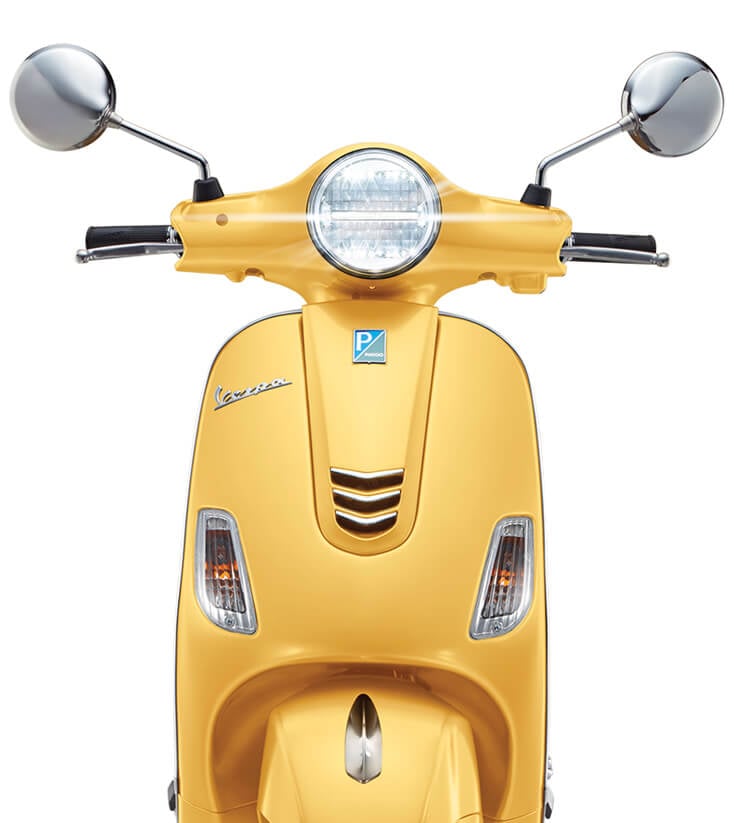 features of yellow vespa scooter